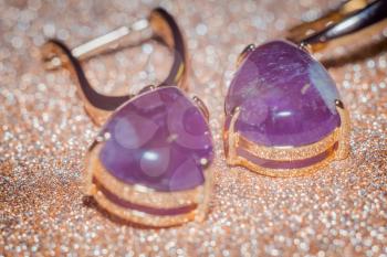 Fashion rose gold earrings made of natural purple amethyst gemstone.