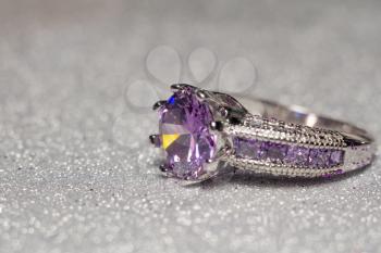 Fashion silver ring with purple zirconia, amethyst imitation.