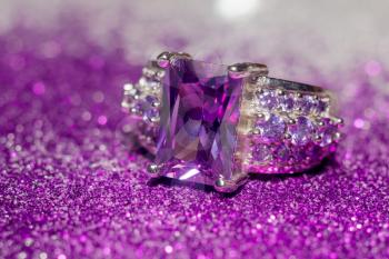 Fashion silver ring with purple zirconia, amethyst imitation.