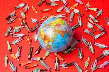 Figurines around globe as death toll. Coronavirus pandemic in world.
