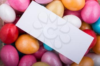 Small piece of empty paper on colorful decorative candies