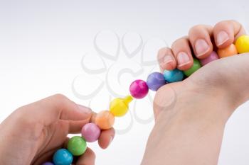 Hand holding Color beads with facial expression on white background
