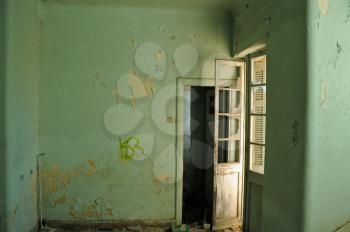 Empty room and textured peeling paint wall. Abandoned house interior.