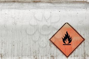 Flammable material weathered warning sign background. Fuel tank.