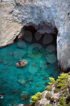 Panoramic view of rocky blue water beach and cave in Keri, Zakynthos, Greece.