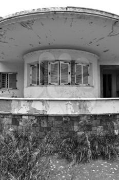 Futuristic house from the 1960s abandoned in ruin. Round roof and porch detail.