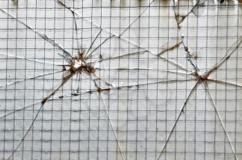 Smashed glass reinforced with wire squares background texture.