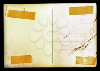 Vintage blank postcard background with adhesive tape stains and ink smudge.