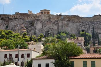 Houses at Plaka neighborhood and the Acropolis walls, Athens, Greece.