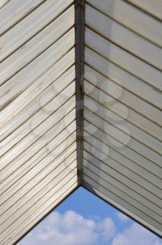 Sunshade plastic roofing and blue sky abstract architecture background.