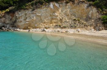 Turquoise sea water and sandy beach. Summer landscape eroded shore.
