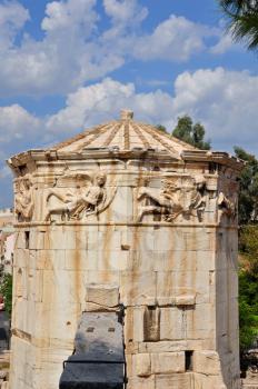Tower of the winds ancient clocktower for monitoring weather and time later a church. Wind gods carved on marble frieze, Athens Greece.