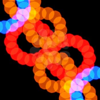 Abstract blurry lights pattern colorful circles on black background.