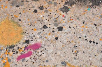 Colorful paint stains on concrete abstract artistic background texture.