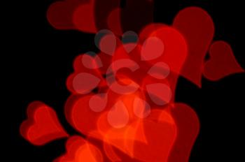 Romantic red hearts on black background. Abstract love background.
