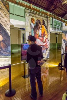 Tacoma, WA, USA - October 11, 2018        Art lovers appreciate the hangings at the Michaelangelo Sistine Chapel art exhiibt. Location is the Tacoma Armory.