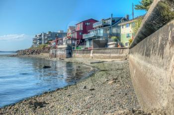 Residences sit above a seawall in West Seattle, Washington. HDR image.