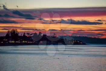 The sky is rich with colors as the sun set at Alki Beach in West Seattle, Washington.