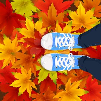 Autumn leaves background template with red, orange, brown and yellow maple leaves legs top view in shoes sneakers