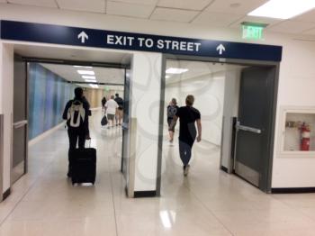 Airport exit to street doors with people blurred