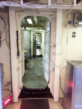 Hallway water tight steel metal doors in passageway of ship on USS Iowa naval warship destroyer battleship