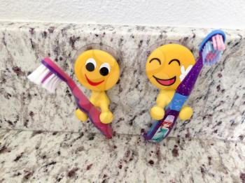Fun yellow emoji smiling dental products toothbrush holders for kids