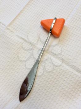 Reflex rubber hammer at doctor office on white sterile background