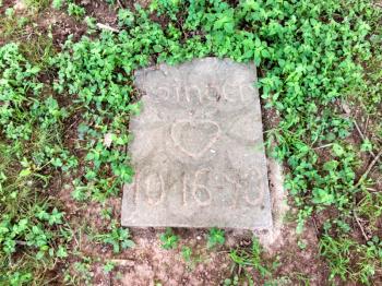 pet gravestone in backyard for favorite dog Ginger
