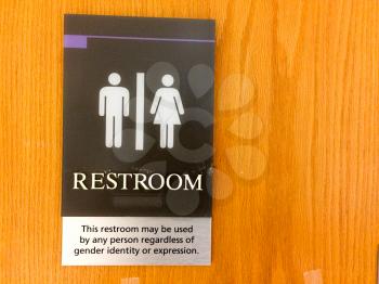 neutral gender identity restoom bathroom door sign man woman