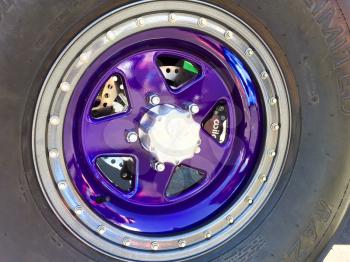 Modern purple car truck wheel and rubber sandrail tire off road racer powder coating