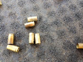 Spent shot lead bullets cartridge casing on black background
