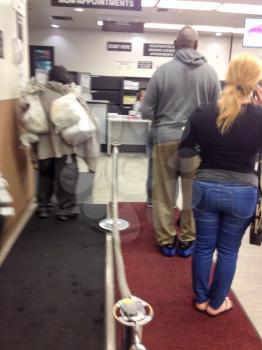 Department of motor vehicles DMV California America people waiting in crowded line indoor government office