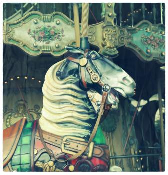 Horse in a carousel at the fair.  Cross processed to look like an aged and instant photo with texture.
