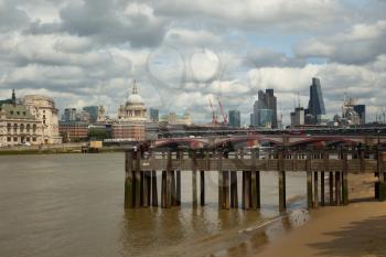 View on a old wharf with the Thames and the city of London in background