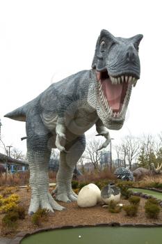 NIAGARA FALLS, CANADA-JANUARY 11, 2016:  Replica of a T-Rex dinosaur with baby in eggs in a mini putt at Niagara falls in Ontario, Canada