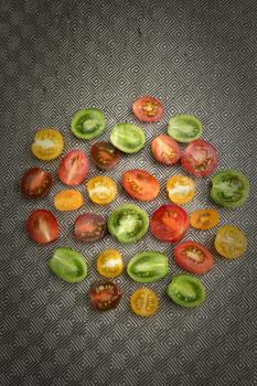 Various colored organics tomatoes cuts