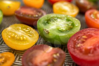 Various colored organics tomatoes cuts