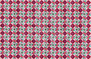 Photographe of traditional portuguese tiles in pink, green and purple